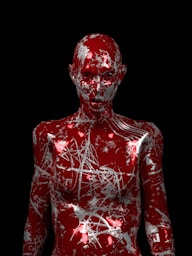 a red body painted with white paint on a black background