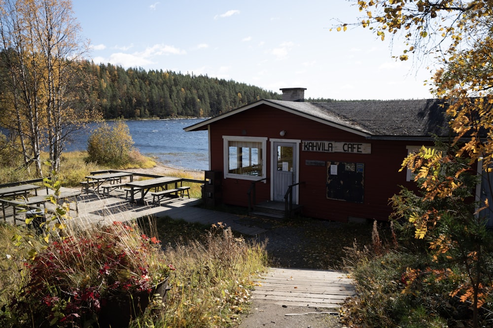 a red building sitting next to a body of water