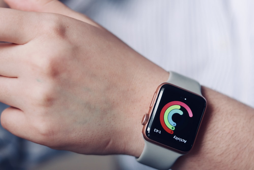 a close up of a person wearing an apple watch