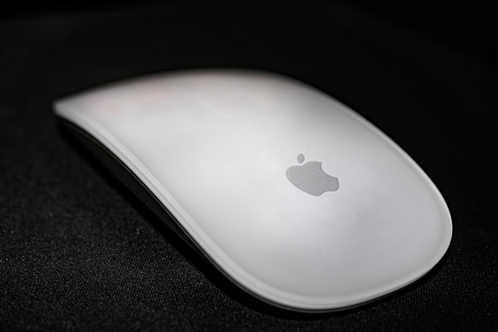 a white apple mouse sitting on top of a table