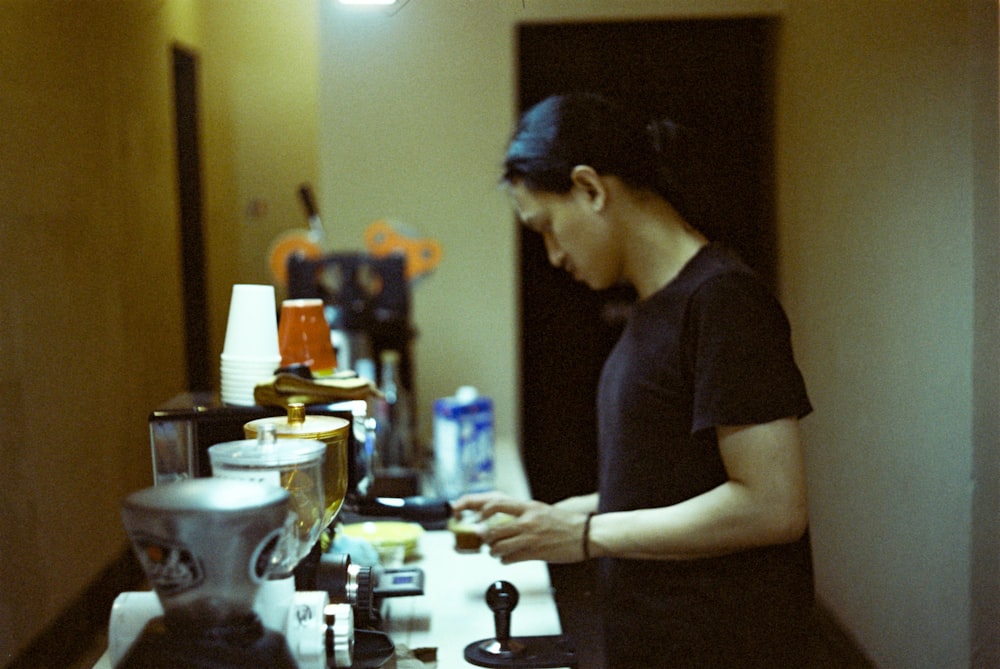 a woman standing in a kitchen preparing food