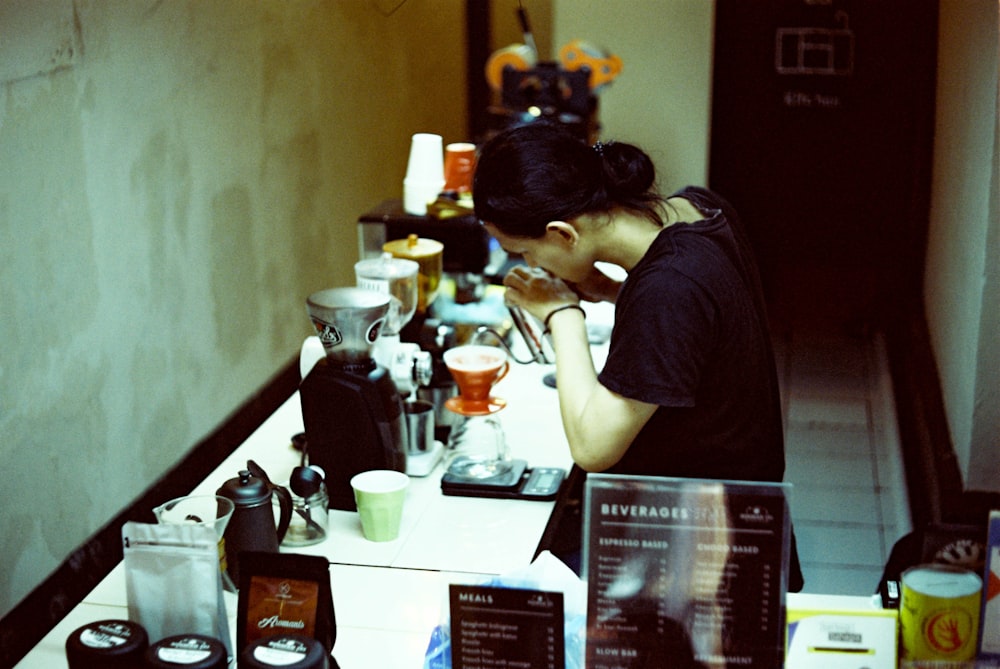 a woman sitting at a counter in a restaurant