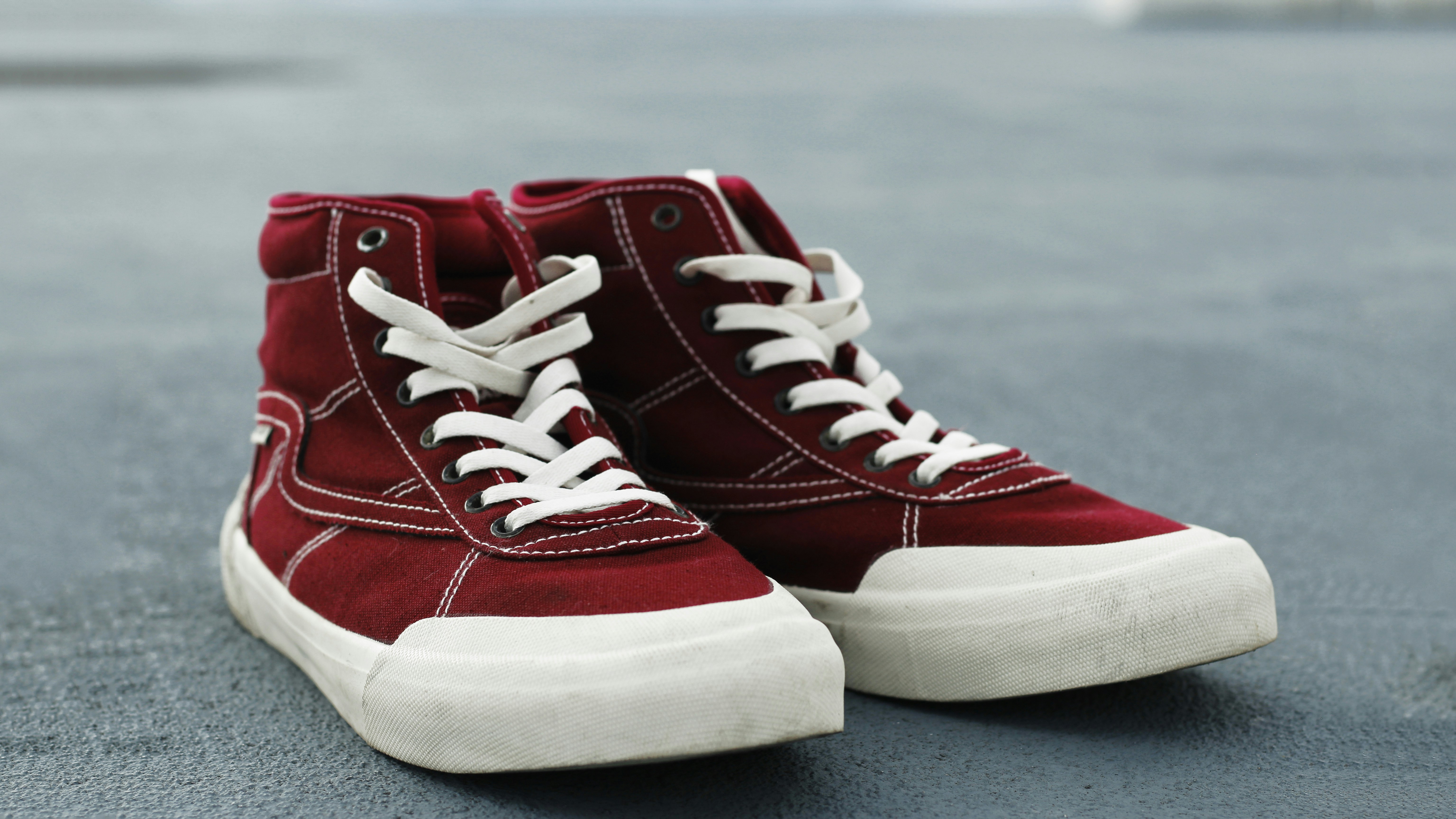 a pair of red sneakers with white laces