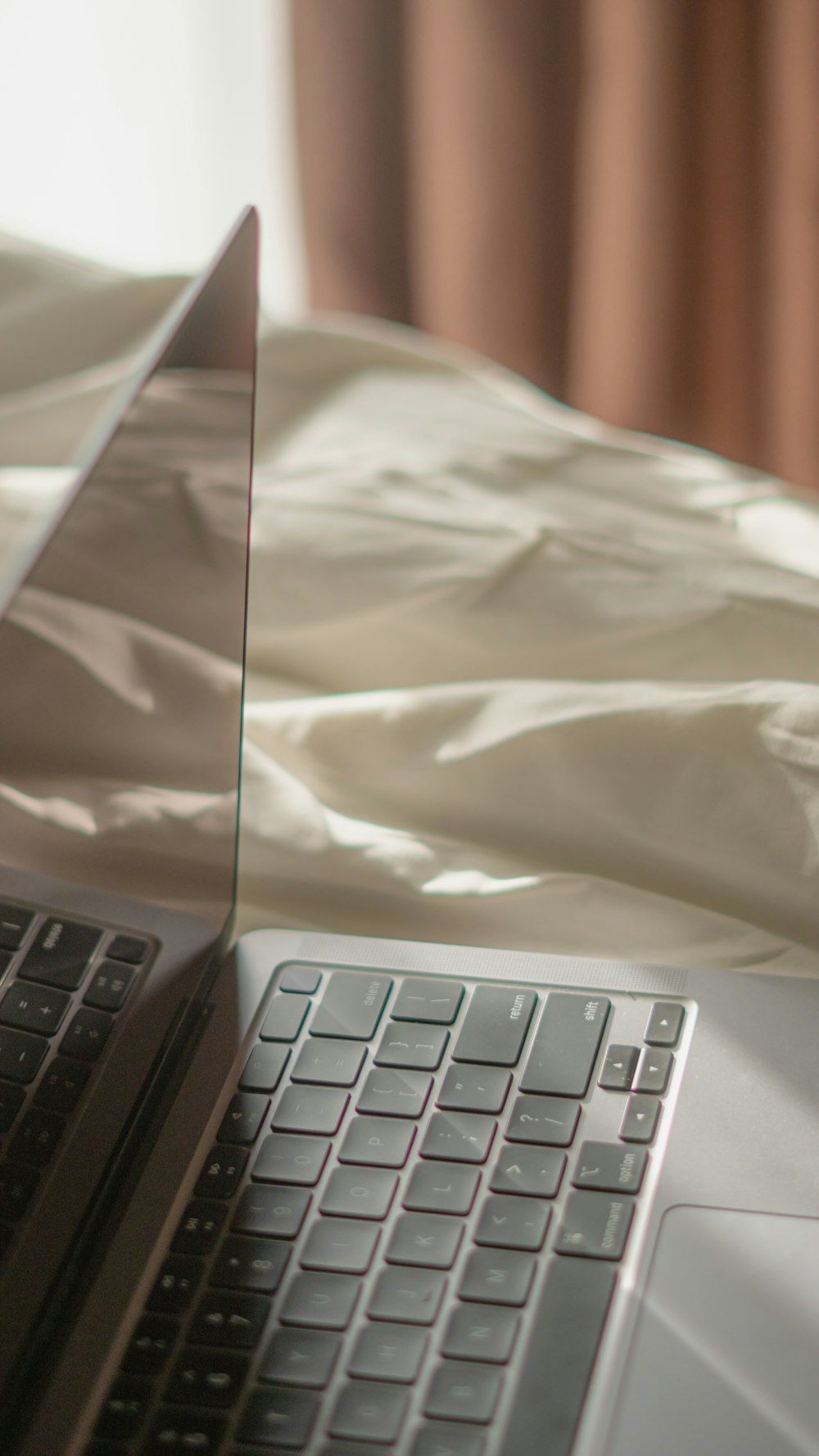 a laptop computer sitting on top of a bed