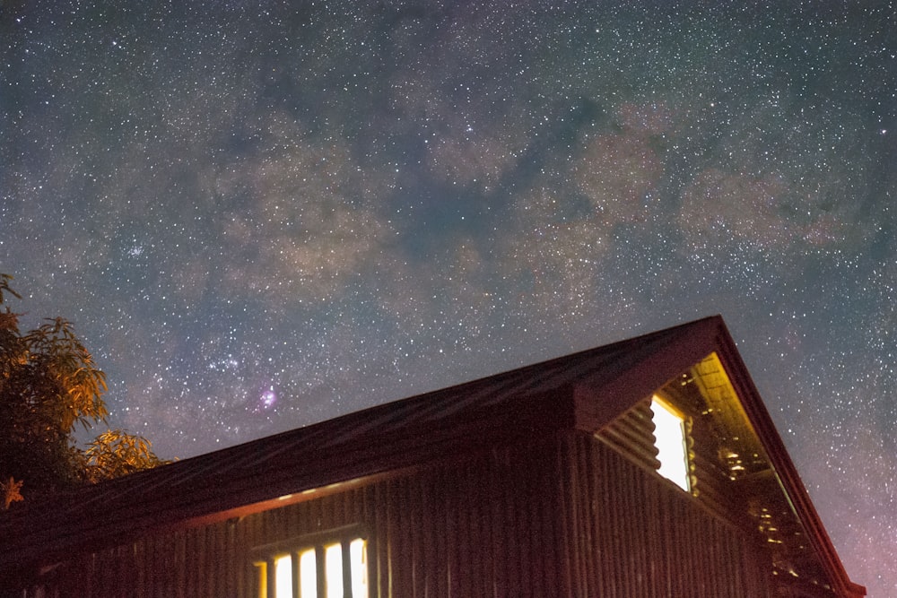 a cabin under a night sky filled with stars