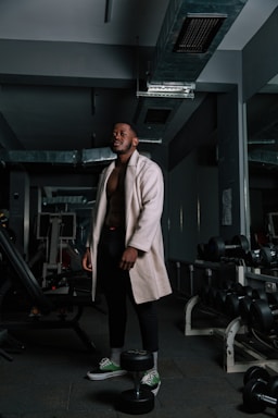 a man standing next to a gym machine