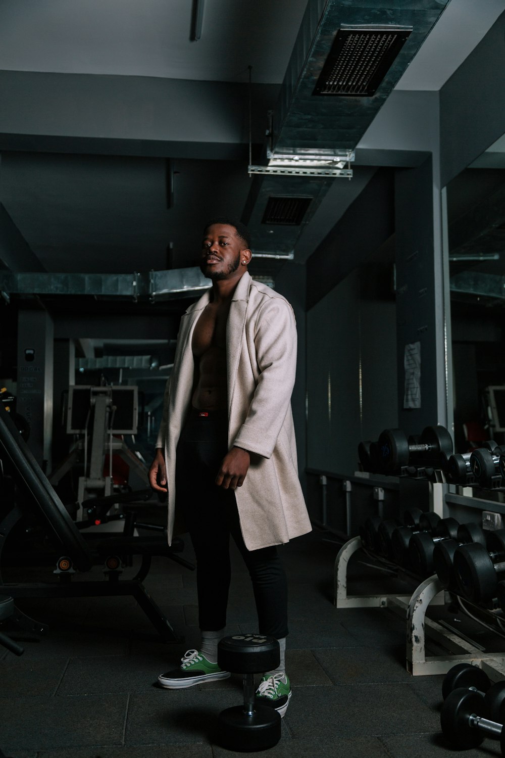 a man standing next to a gym machine