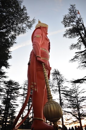 a statue of a man holding a large ball
