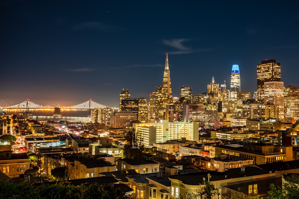 a view of a city at night with a bridge in the background