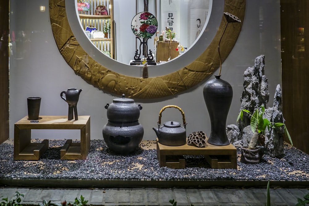 a mirror and some vases on a table