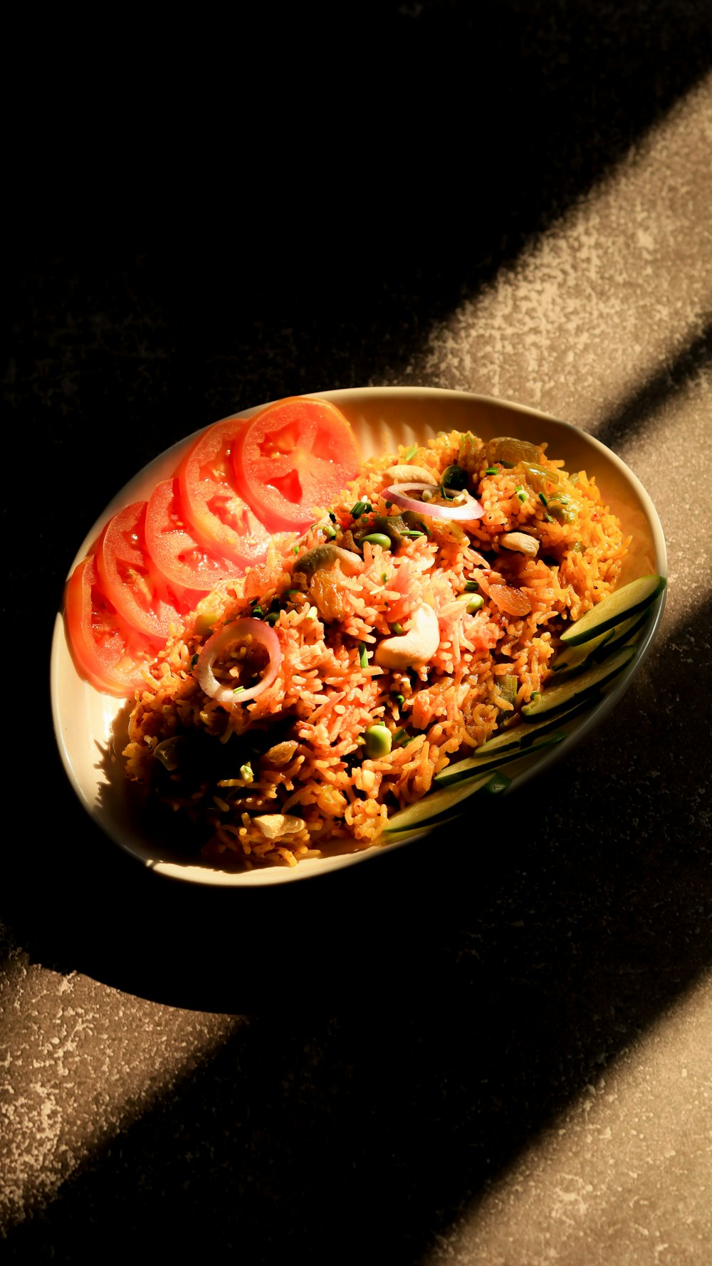 a plate of food with tomatoes and rice