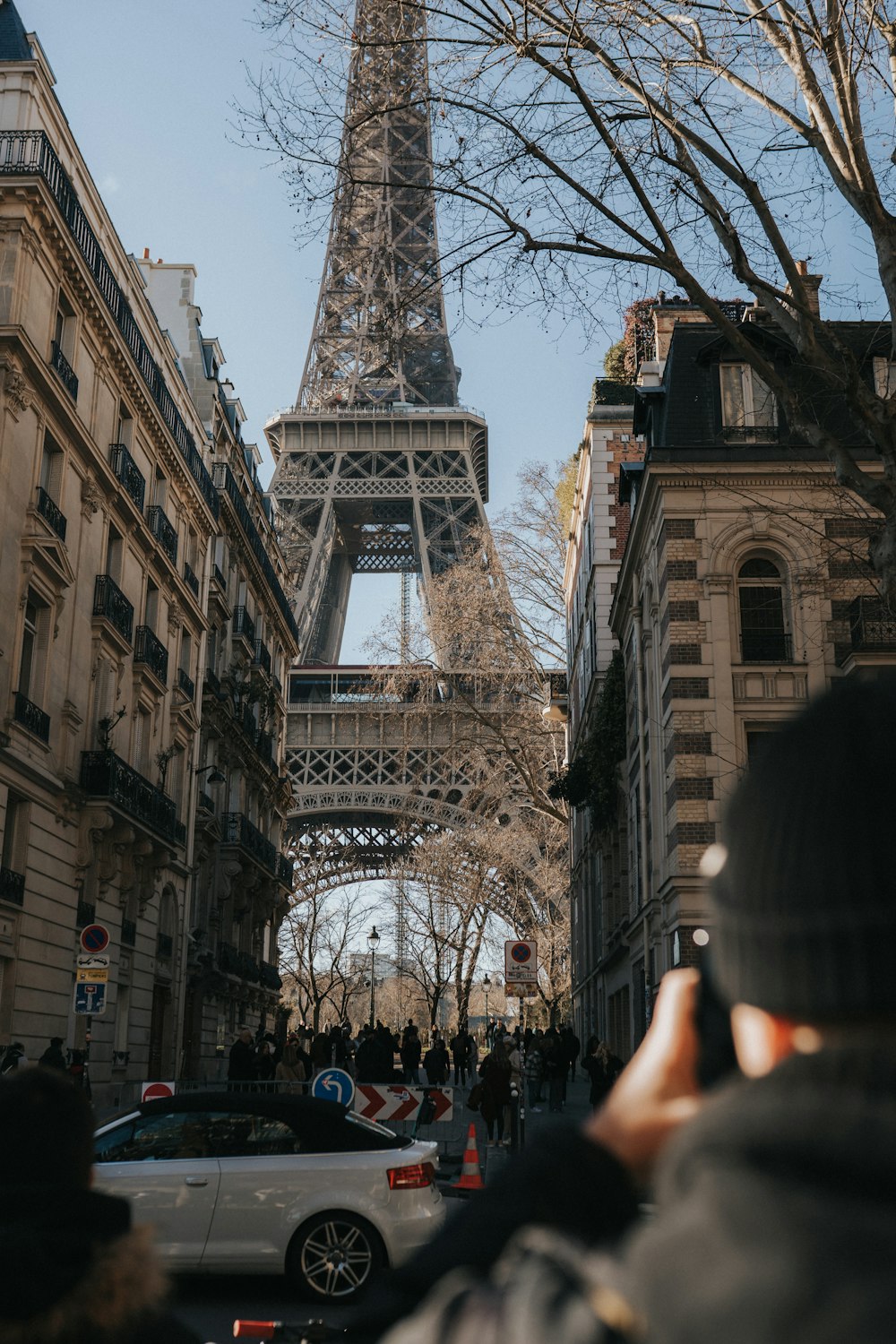 a person taking a picture of the eiffel tower