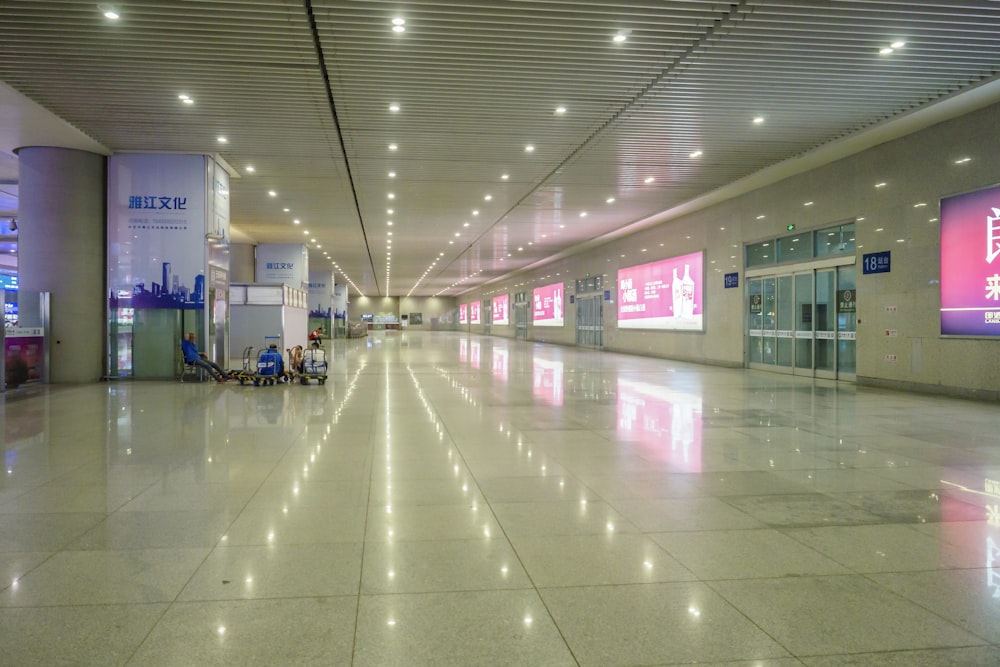 an empty airport terminal with people sitting at their desks