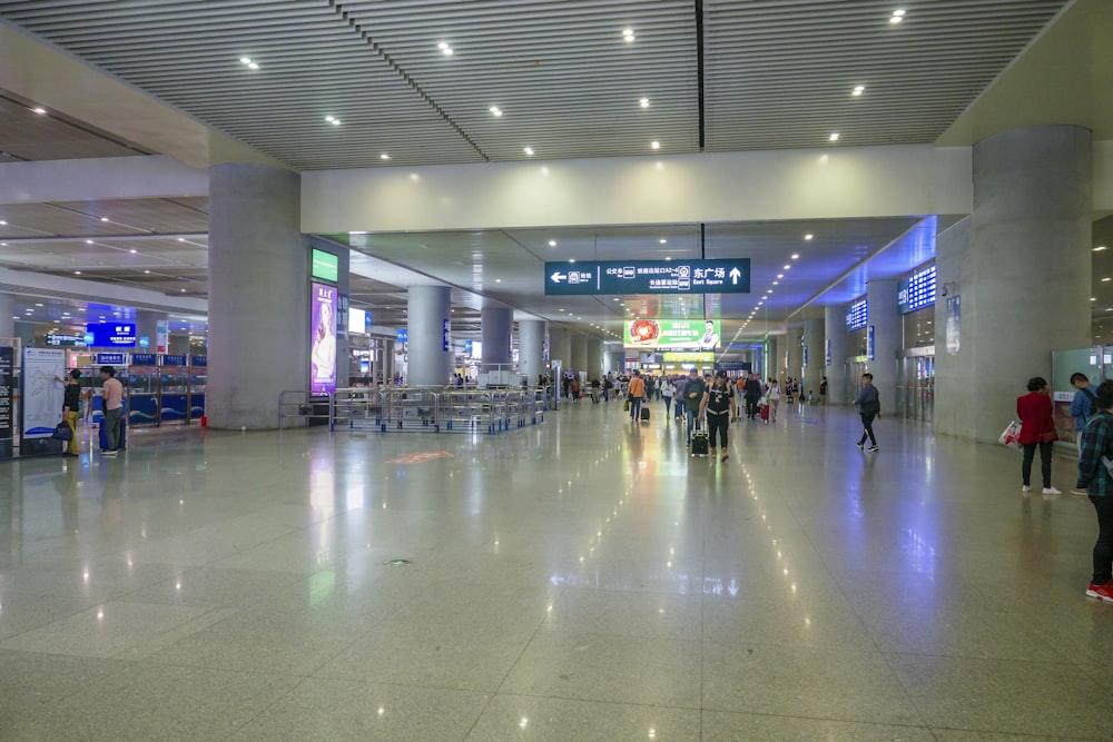 a group of people walking through an airport