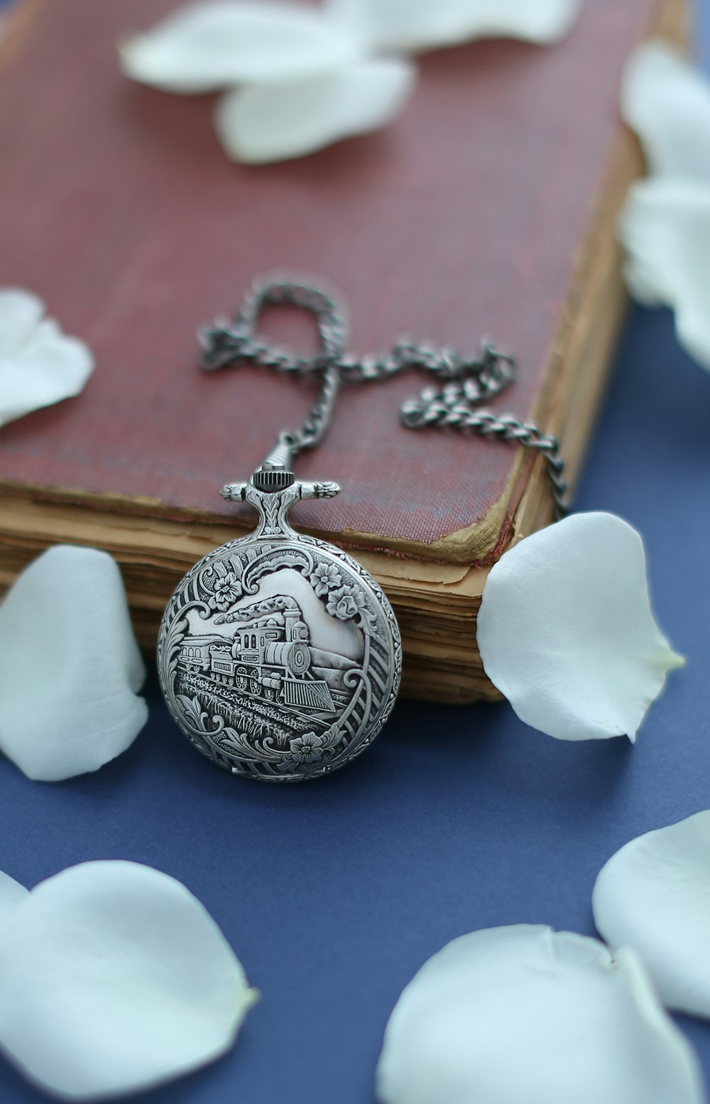 a pocket watch sitting on top of a book