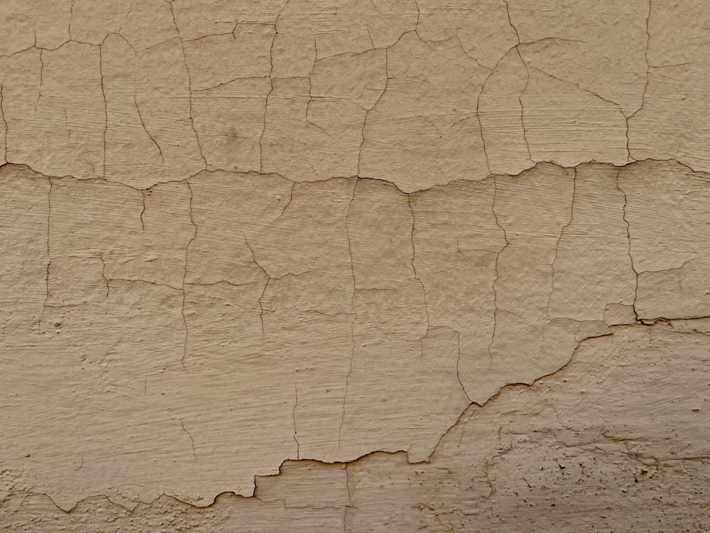 a close up of a wall with cracks in it