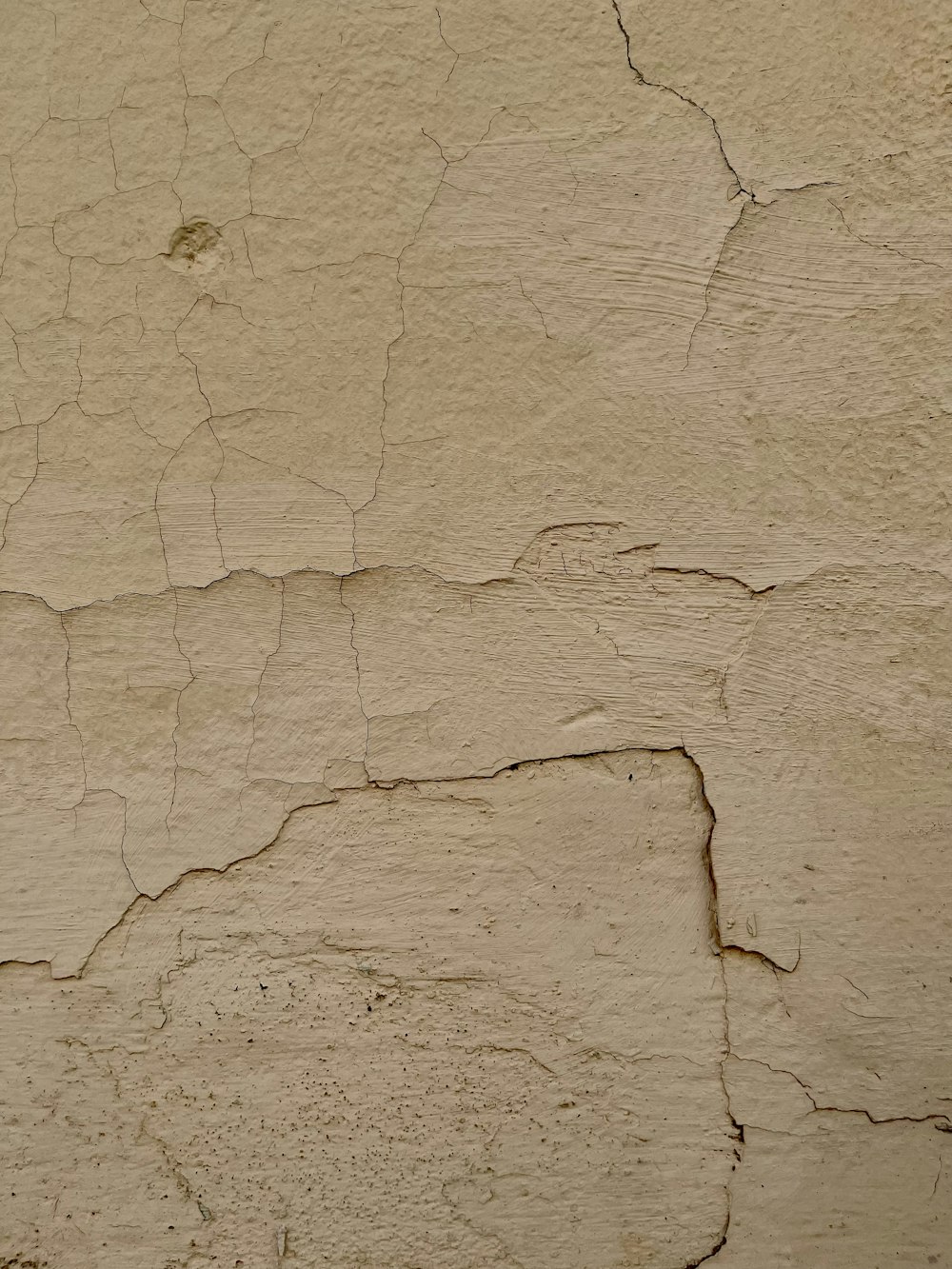 a close up of a wall with cracks in it