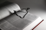 an open book with a chain on top of it