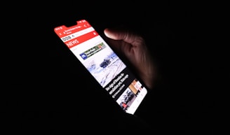 a person holding a cell phone in their hand