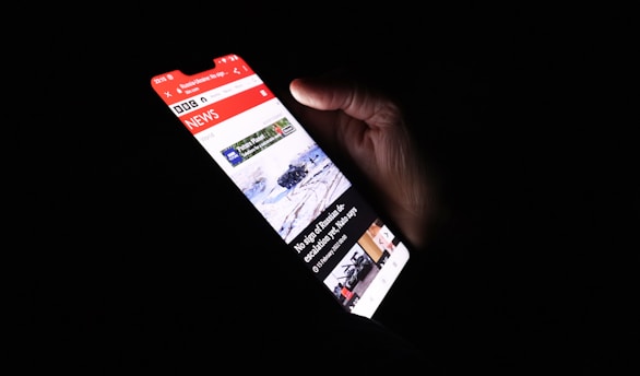 a person holding a cell phone in their hand