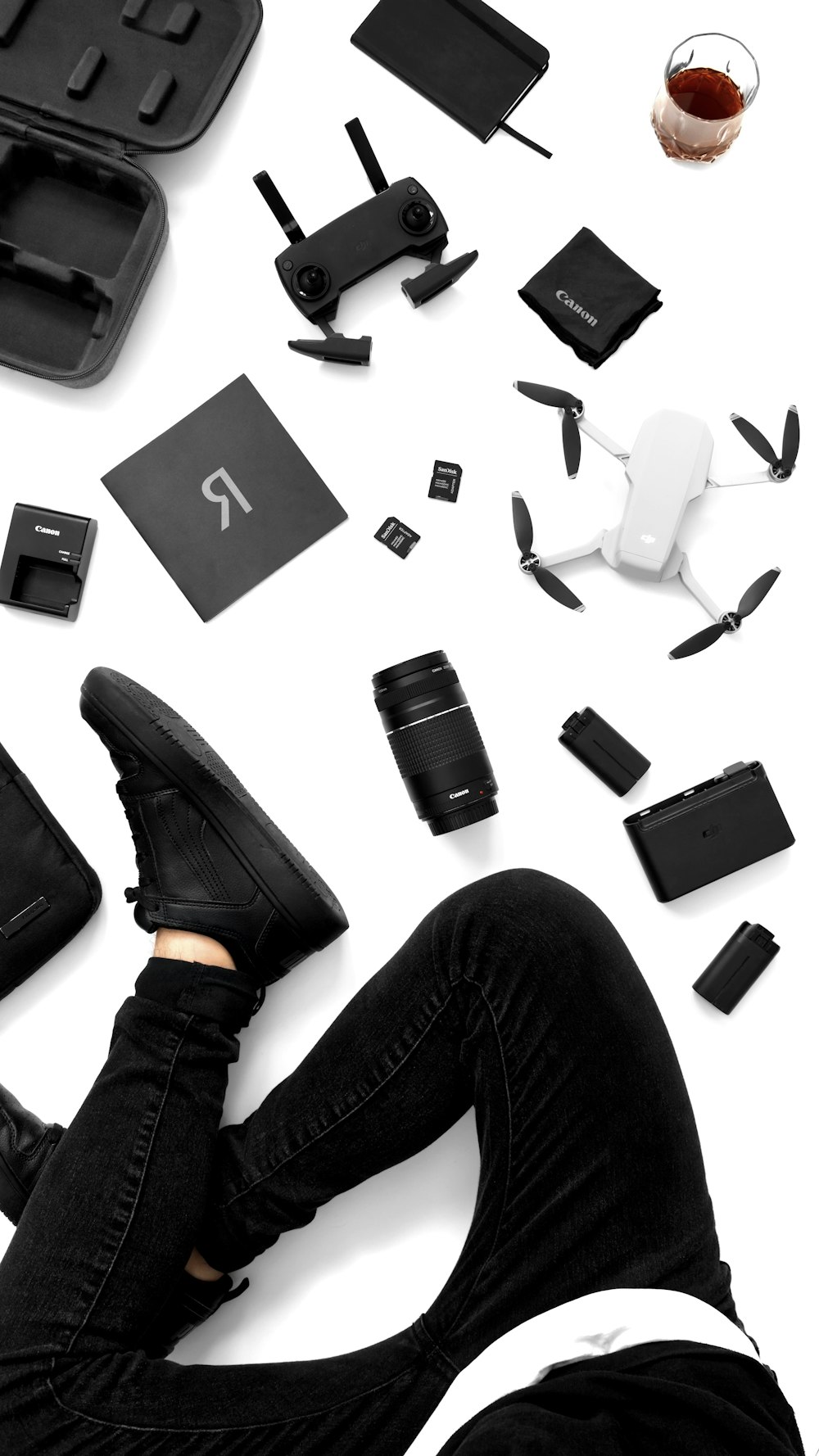 a person laying on the ground surrounded by electronics