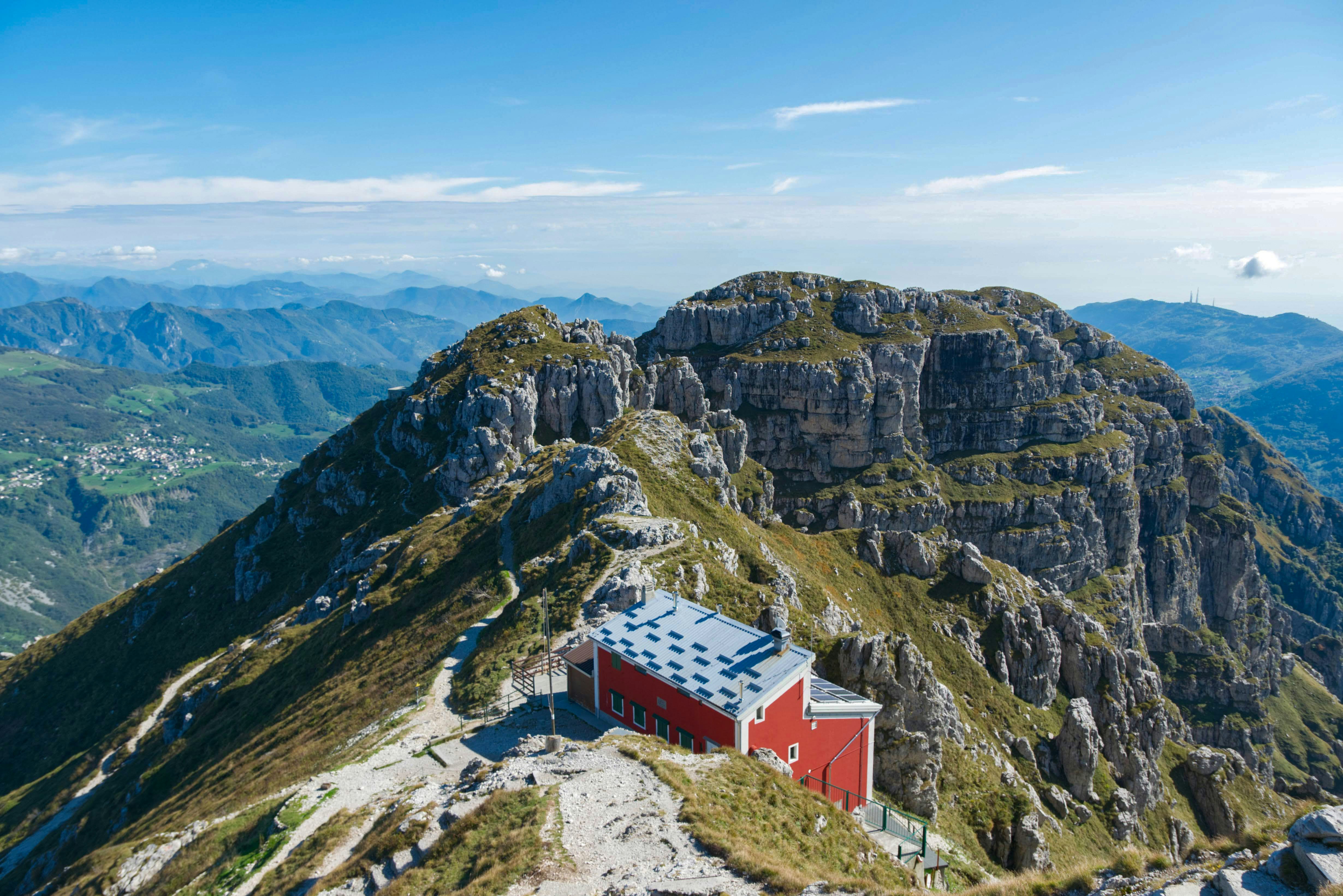 a small red building on the side of a mountain