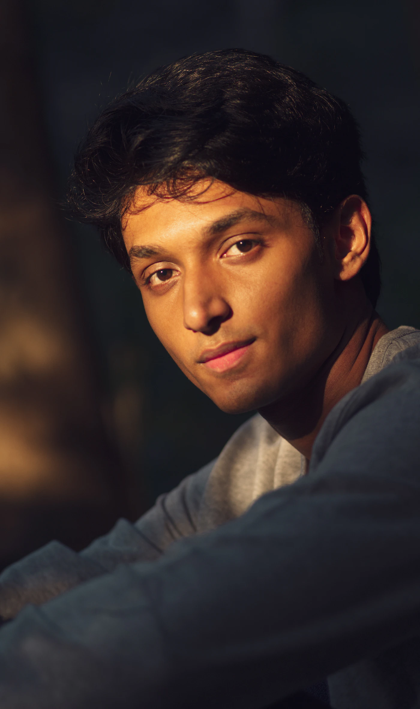 Close-up side-profile portrait of a person against a neutral background, clean editorial lighting clearly showing the chin and jawline, representing the treatment area for chin filler