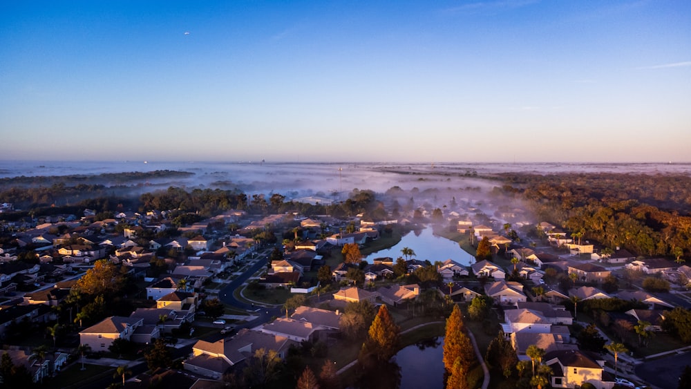 an aerial view of a city with a lake in the foreground