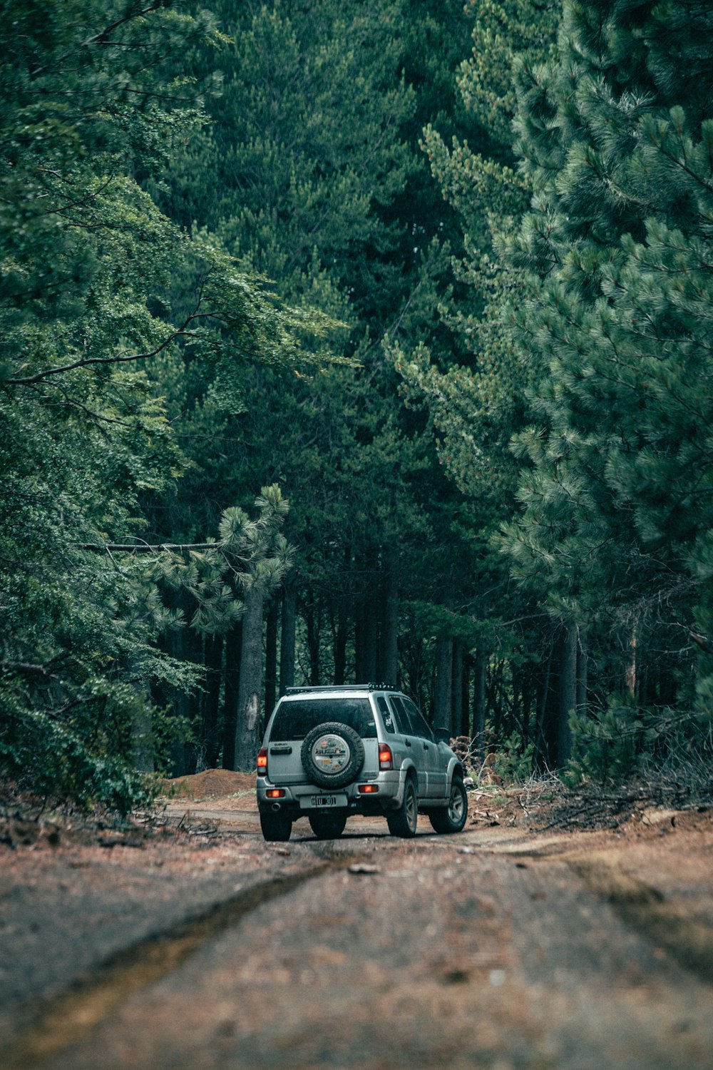 a truck traveling down a dirt road