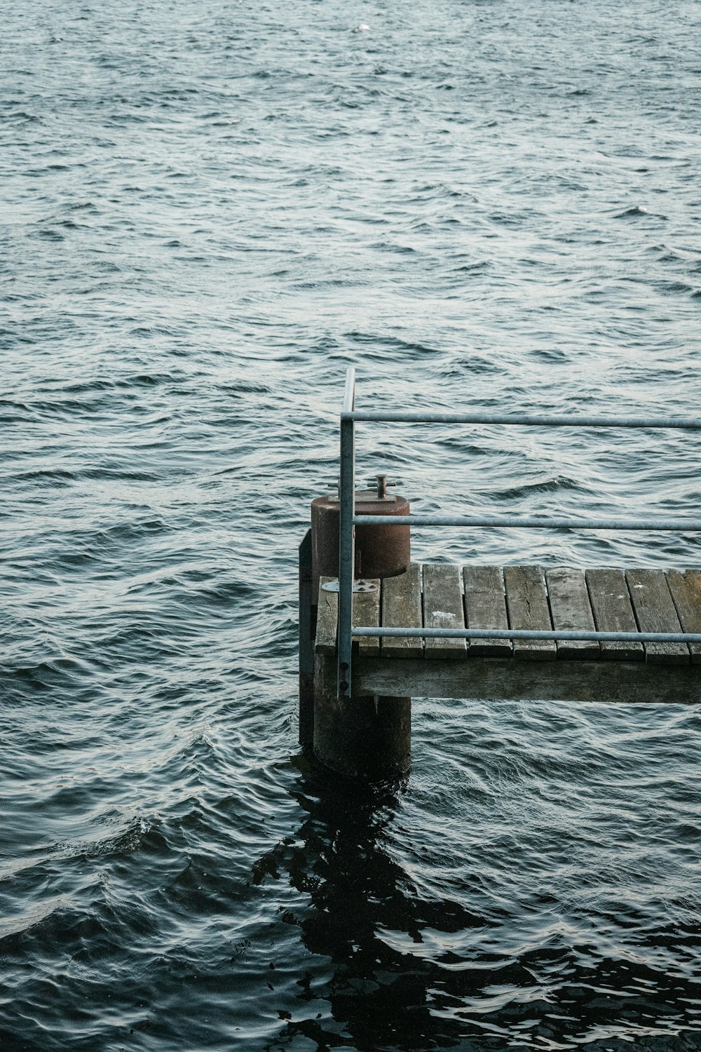 a wooden dock in the middle of a body of water