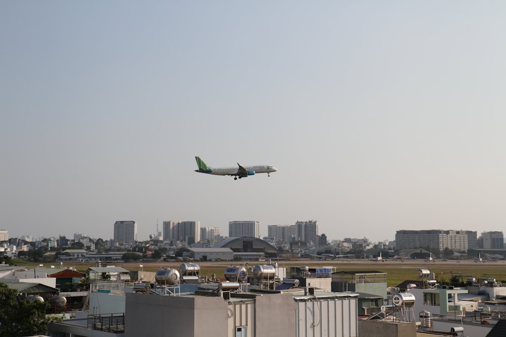 an airplane flying over a city with buildings