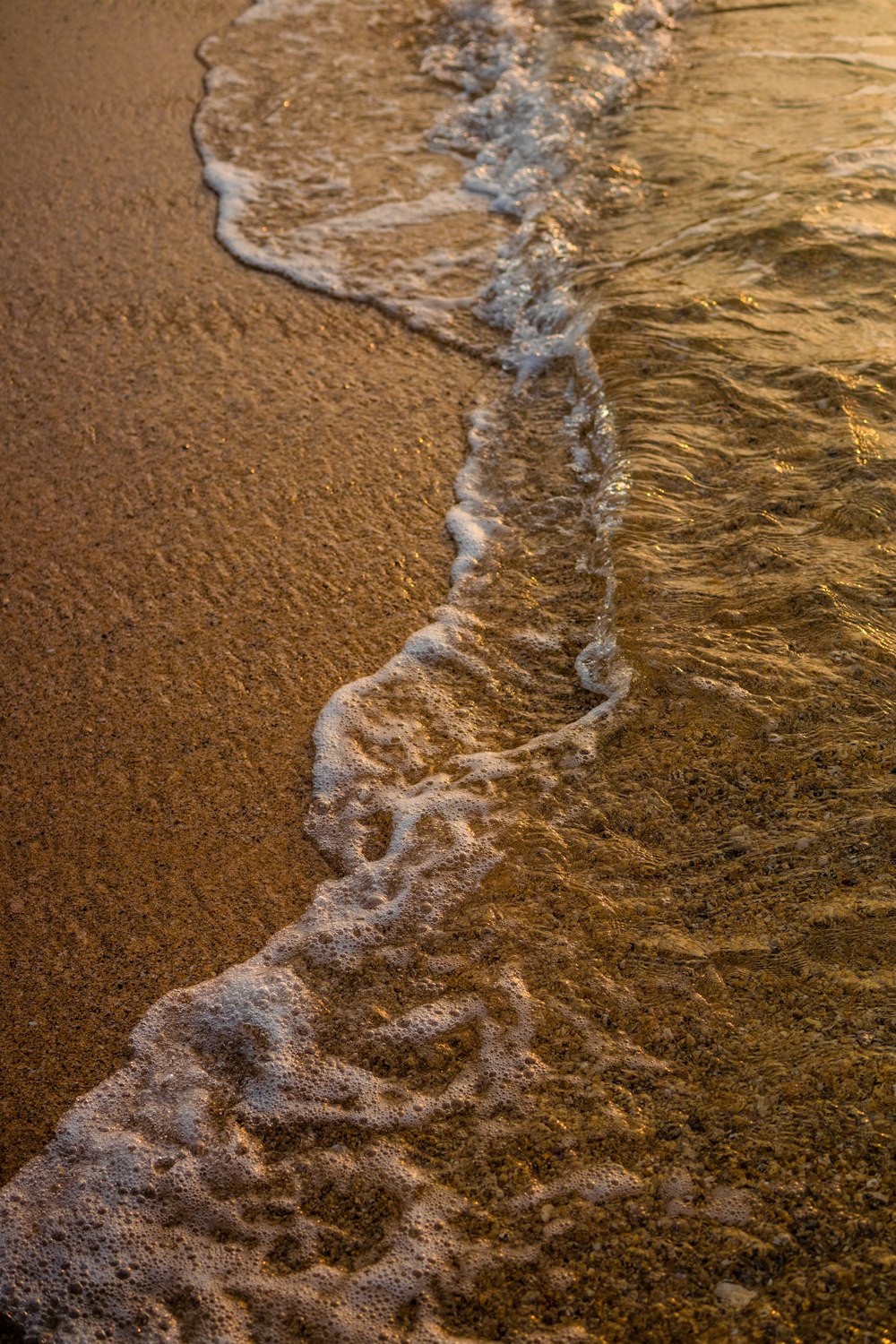 a close up of a wave on a beach