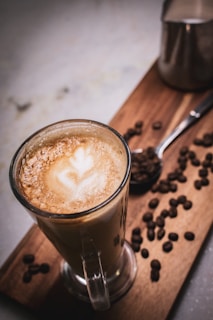 A collection of coffee beans and tools used for making latte art.