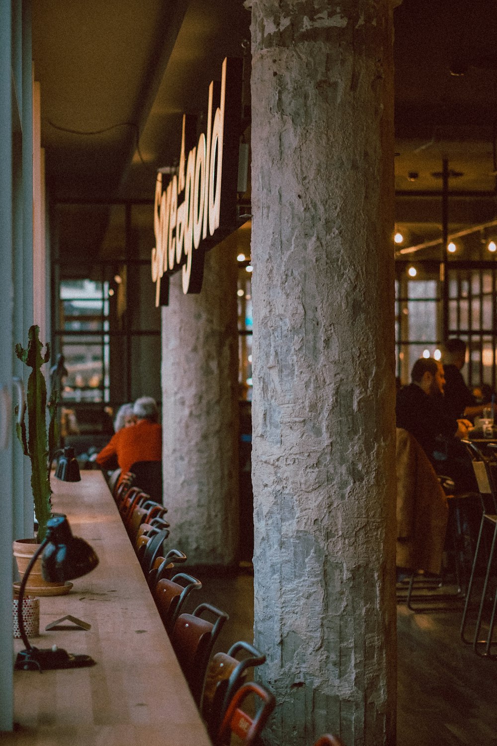 a group of people sitting at tables in a restaurant