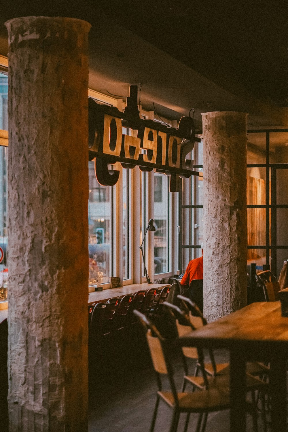 a restaurant with a wooden table and chairs