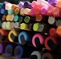 a close up of many different colored markers