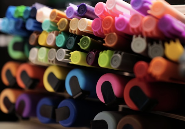 a close up of many different colored markers