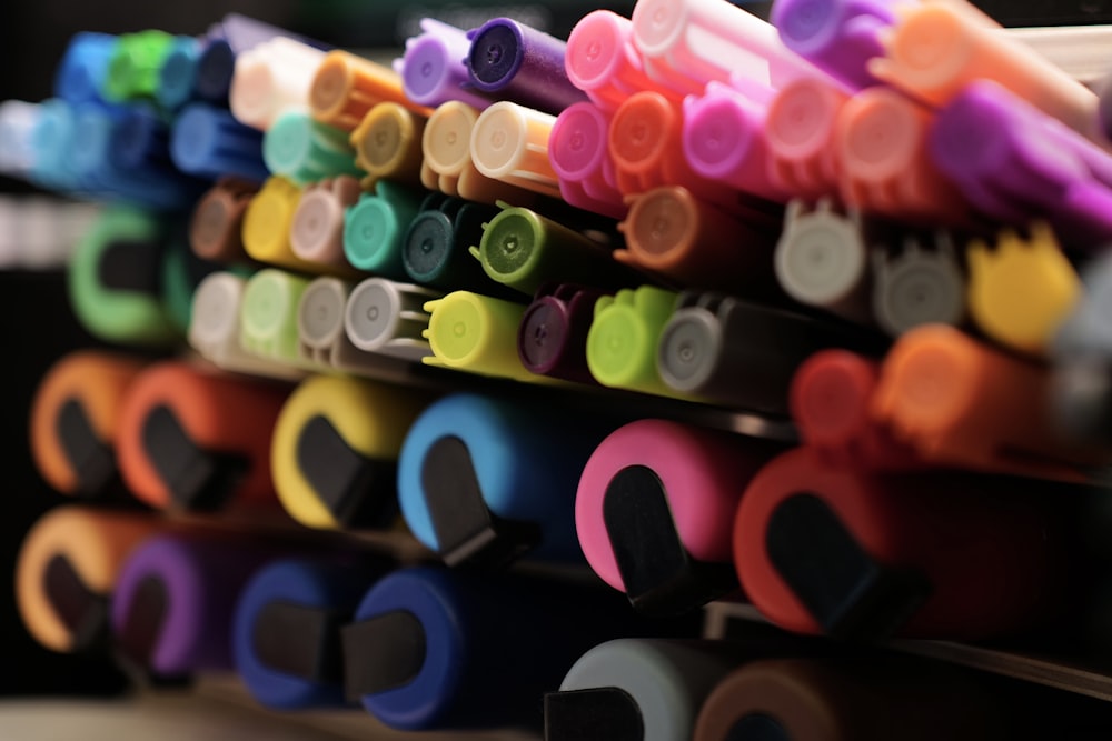 a close up of many different colored markers