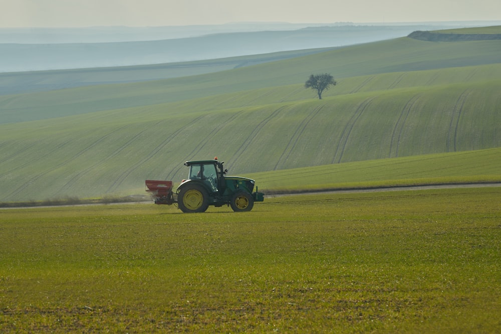 a tractor is driving through a green field