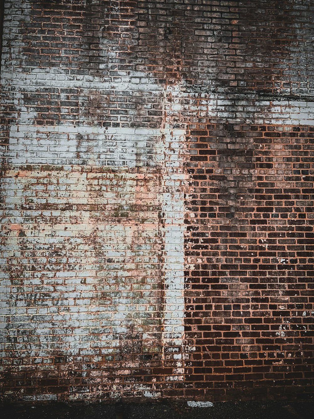 a brick wall with peeling paint on it