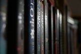 a row of books sitting on top of a shelf