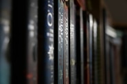 a row of books sitting on top of a shelf