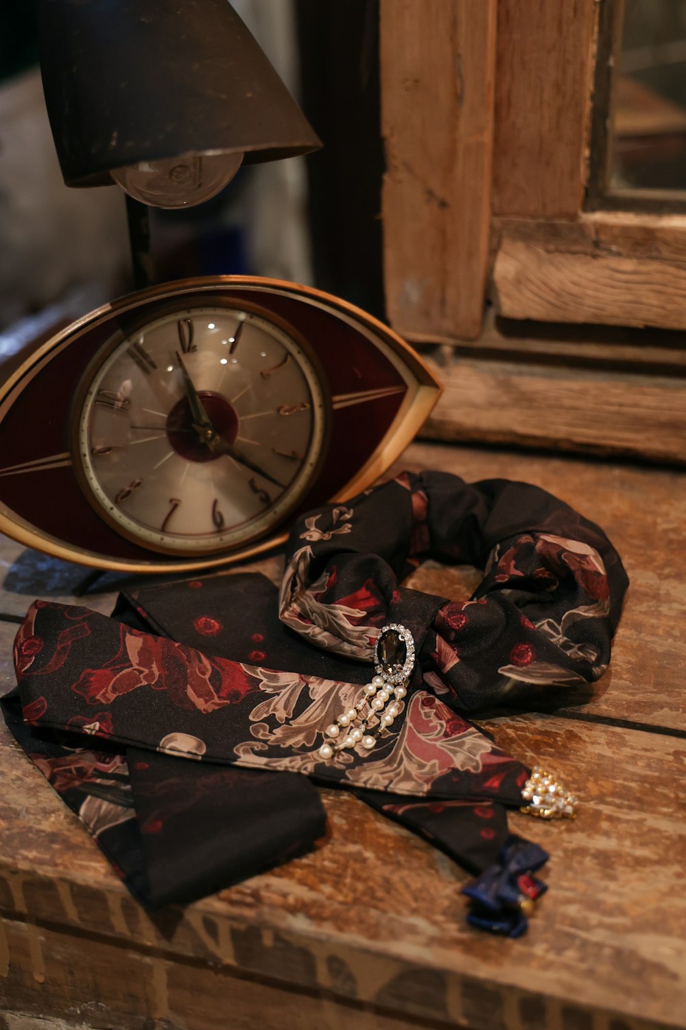 a clock and a scarf on a table