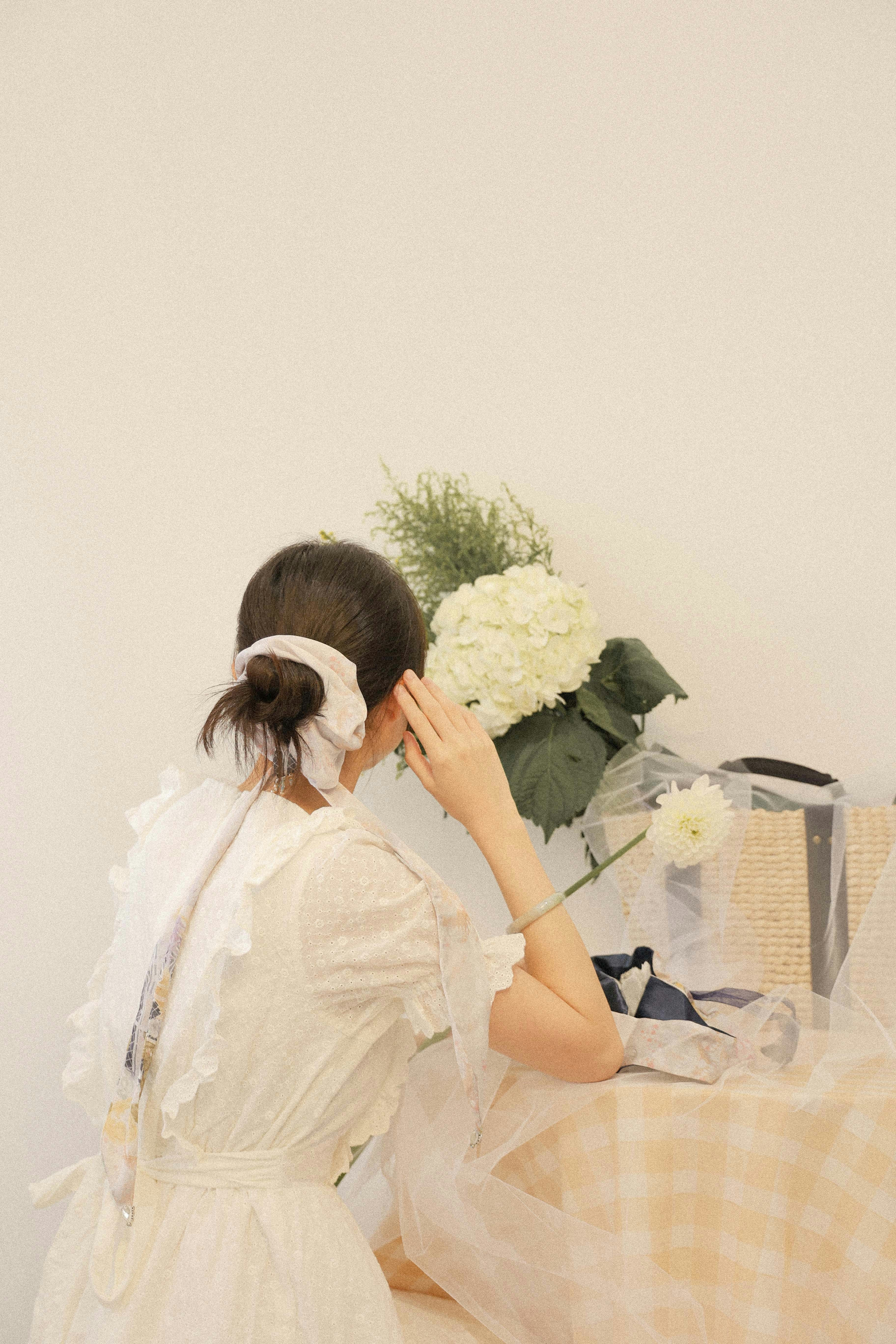 woman wearing yellow long-sleeved dress under white clouds and blue sky during daytime