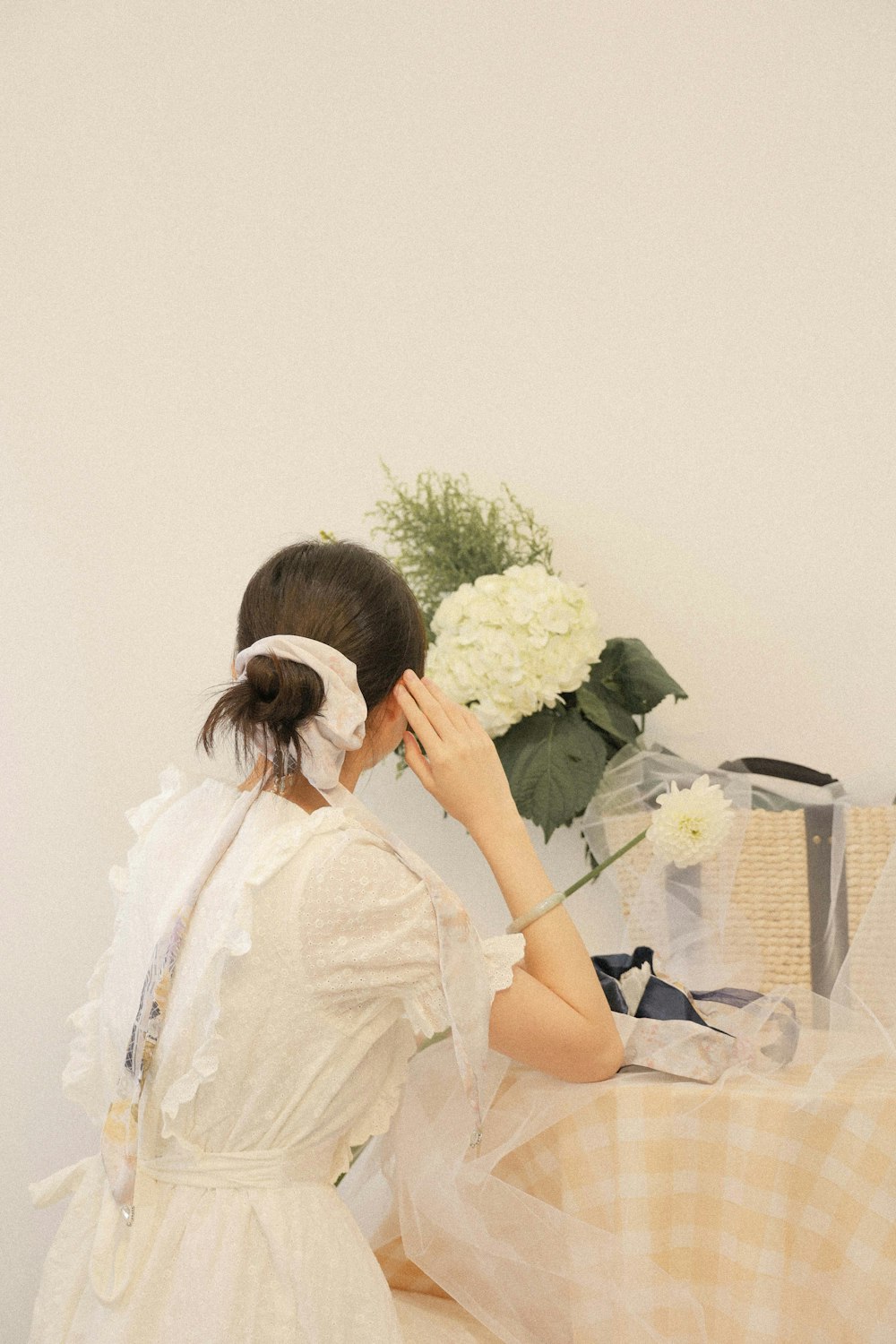 a woman in a white dress and a bouquet of flowers