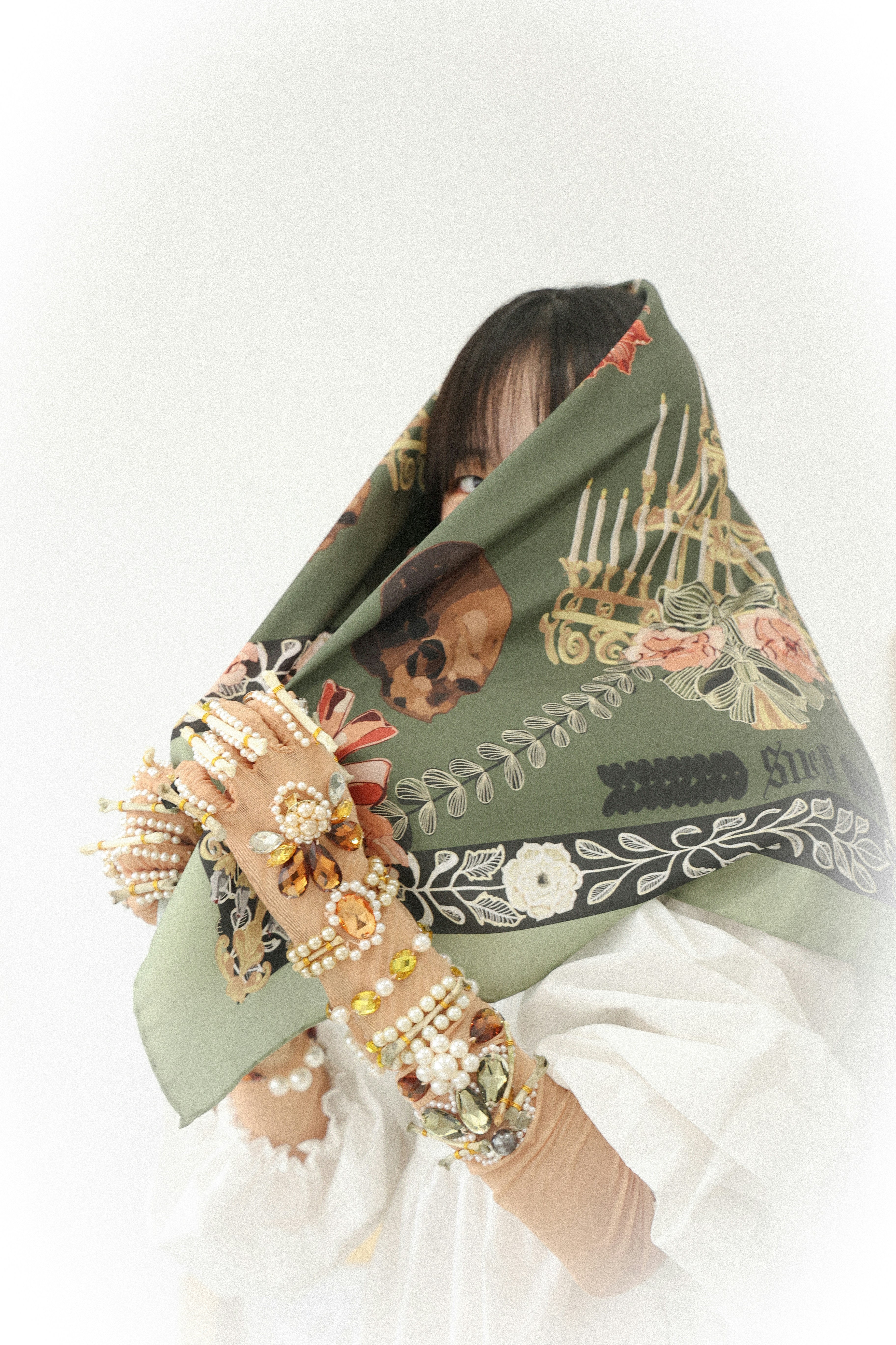 a woman wearing a scarf with a skull on it