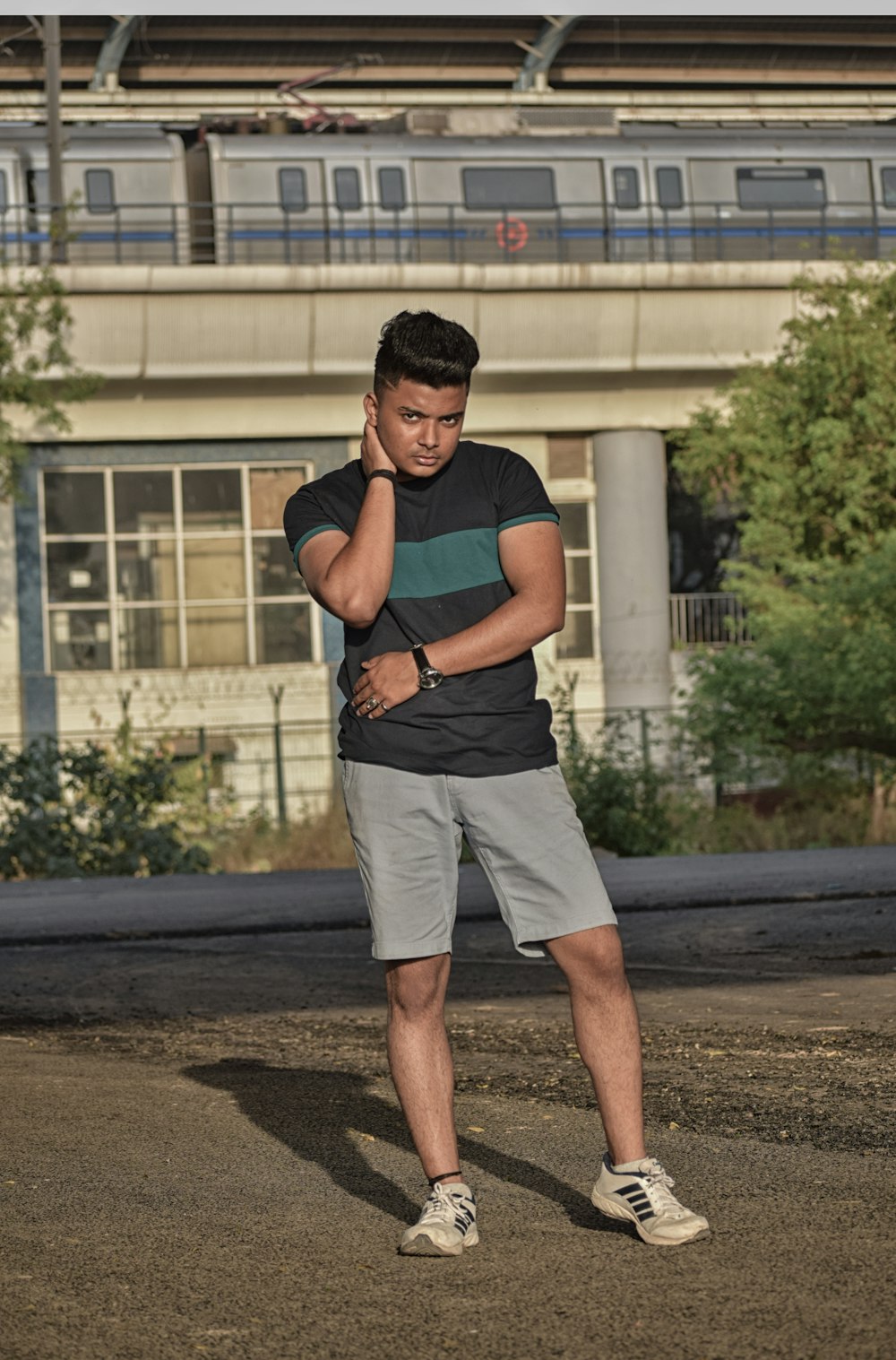 a man standing in a parking lot talking on a cell phone