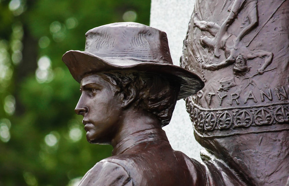 a close up of a statue of a man wearing a hat