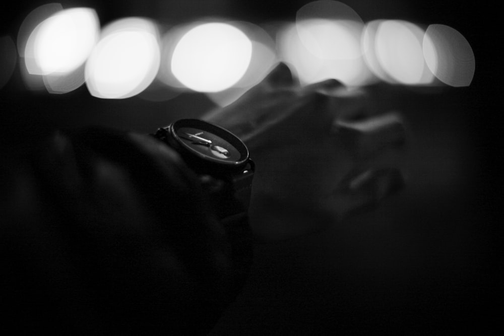 a black and white photo of a wrist watch