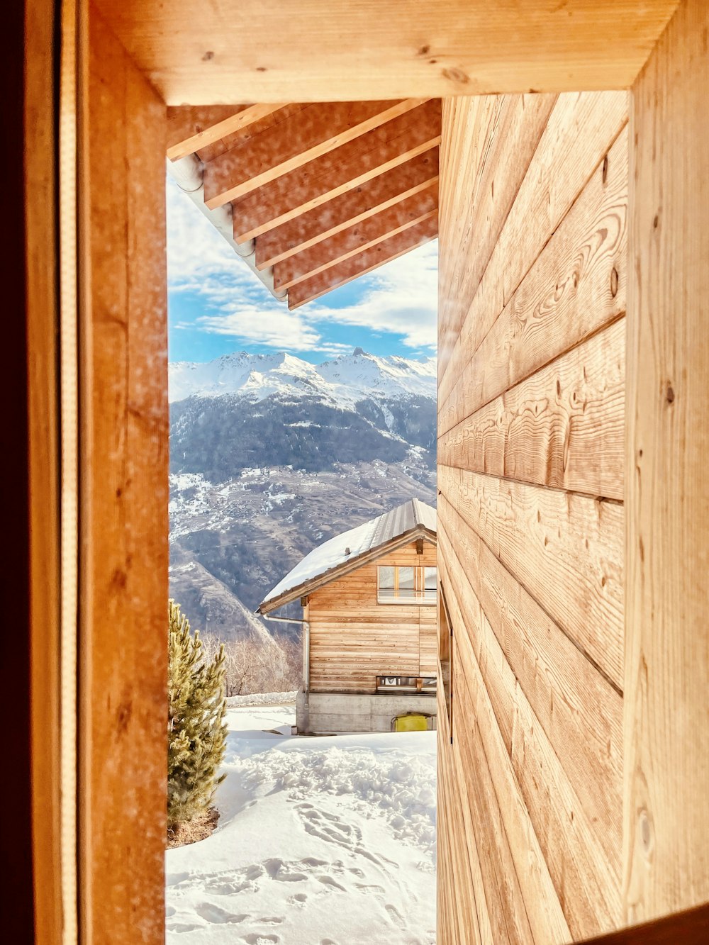 an open door leading to a wooden cabin